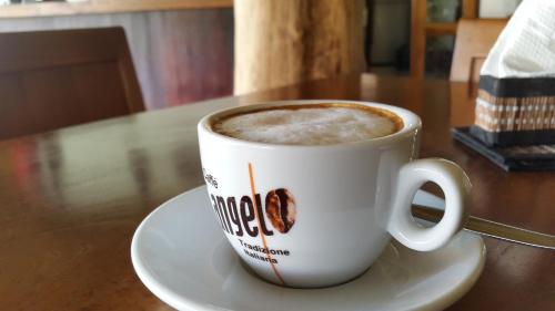 a cup of coffee sitting on a table at The Calmtree Bungalows in Canggu
