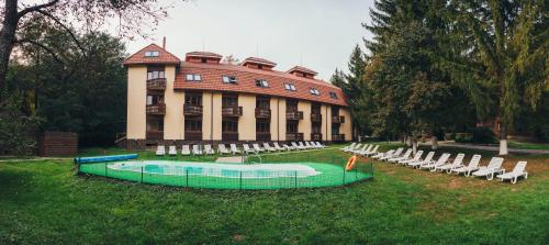a large building with a pool in front of it at Sanatoriy Karpatia in Shaian
