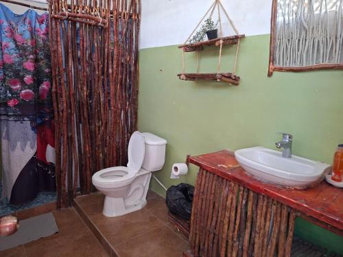 a bathroom with a toilet and a sink at Bayahibe Essentials Rooms in Bayahibe