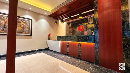 a lobby of a restaurant with a counter at Odissey Suites in Bhubaneshwar