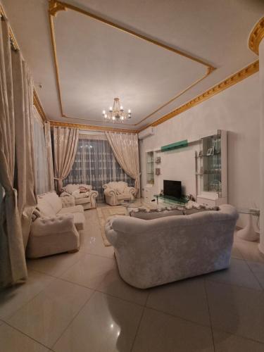 a large living room with a large couch and a television at Kalanar villa in Elbasan