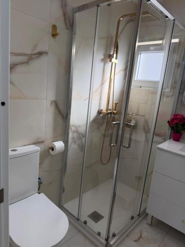 a bathroom with a shower with a white toilet at Villa Mery Montserrat in Piera