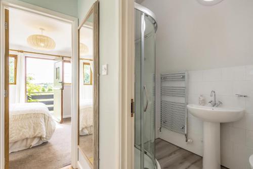 a bathroom with a sink and a glass shower at 2 Bed in Woodbridge oc-owls in Ufford