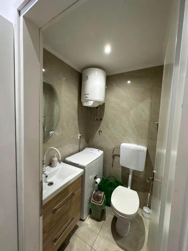 a bathroom with a white toilet and a sink at MiR in Stolac
