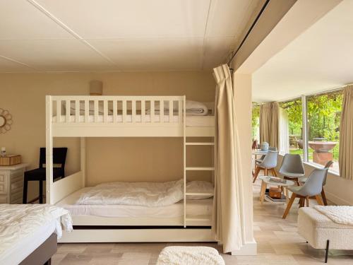a bedroom with two bunk beds and a desk at Charming chalet with Pond in Kortessem in Tongeren