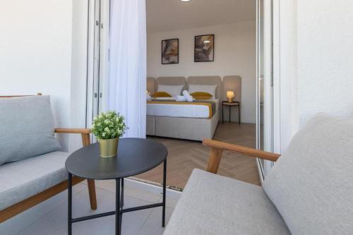 a small living room with a bed and a table at Villa Gaj 2 in Novalja