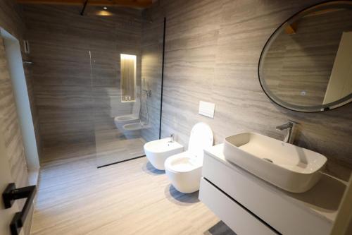 a bathroom with a toilet and a sink and a mirror at Kruja Gate in Krujë