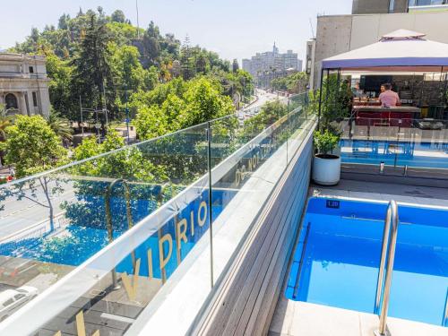 a swimming pool on the roof of a building at Mercure Santiago Centro in Santiago