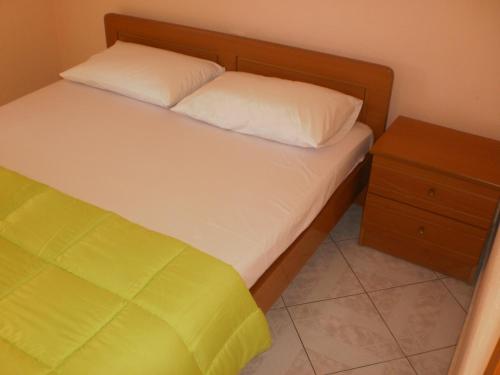 a bedroom with a bed and a night stand at Zavrakli in Agia Paraskevi