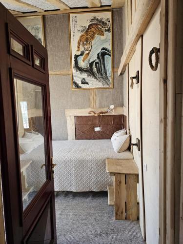 a bedroom with a bed and a picture of a tiger at Eco Retreat Saunahaus in Putgarten