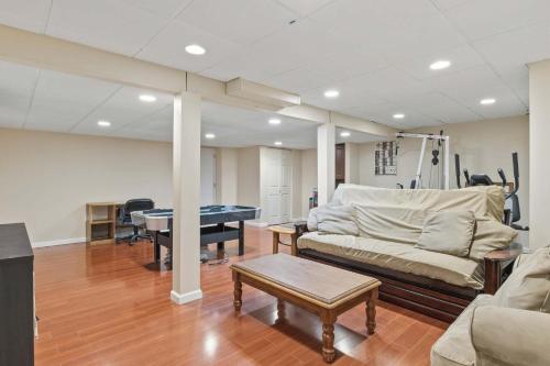 a living room with a couch and a pool table at Spacious Edgewater Home Deck & Sleeps 10 in Edgewater