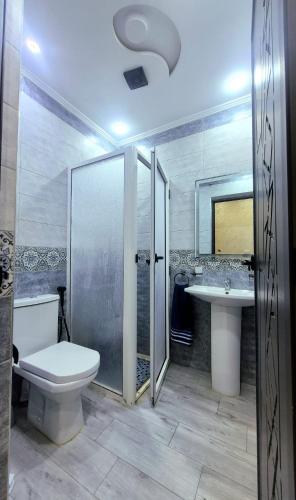 a bathroom with a toilet and a sink at Beachfront First floor mekad in Oued Laou