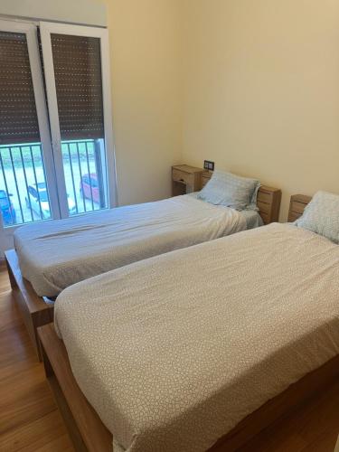 two beds sitting next to each other in a bedroom at Pilgrims House II in Lourenzá