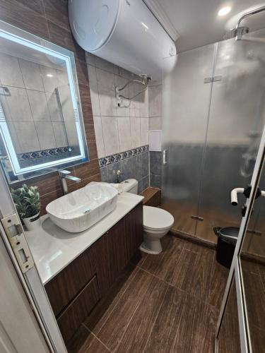 a bathroom with a sink and a toilet and a shower at Стаи под наем Иви - Равда in Ravda