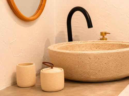 a bathroom sink and two candles on a counter at Pátio 38 do frade in Aldeia do Mato