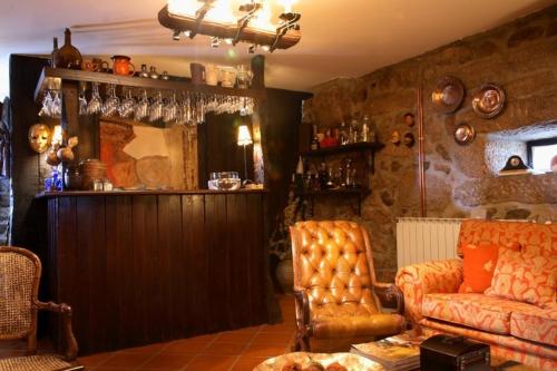 a living room with a couch and a chair at Casa do Meio do Povo - Turismo de Habitação in Chaves