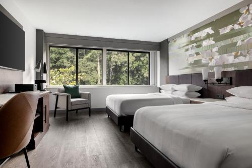 a hotel room with two beds and a window at Atlanta Marriott Peachtree Corners in Norcross