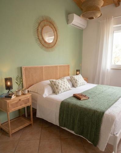 a bedroom with a bed with a table and a mirror at Terrazza Ganzaria in San Michele di Ganzaria