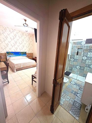a bedroom with a bed and a room with a window at Bed & Breakfast Delle Palme in Trapani