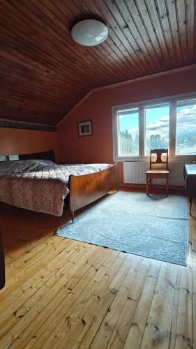 a bedroom with a large bed and two windows at Inka's Guesthouse in Alavus