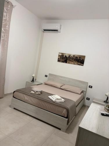 a bedroom with a bed in a white room at Giusi home in Cologno Monzese