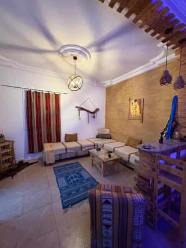 a living room with a couch and a table at Dar Chahla in Tozeur