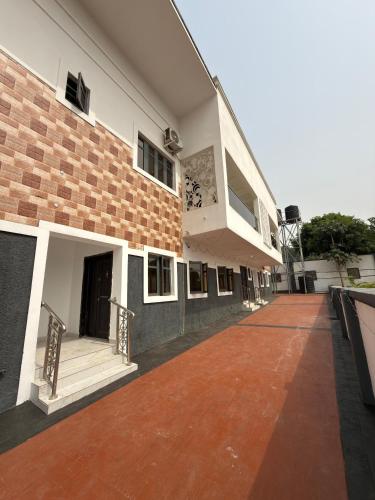 a building with a walkway in front of it at Oak Serviced Apartment-New Bodija in Ibadan