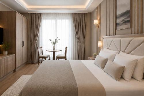 a hotel room with a large bed and a table at Roza Taksim in Istanbul