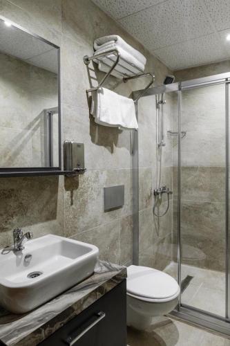 a bathroom with a sink and a toilet and a shower at Roza Taksim in Istanbul