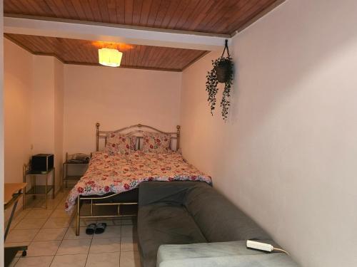 a bedroom with a bed and a couch at B&B Mercator in Ostend