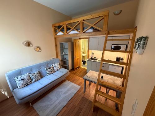 a living room with a couch and a bunk bed at Pas Jūrate Villa Hubertus in Juodkrantė