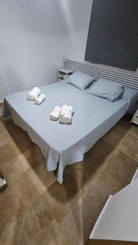 a large white bed with towels on top of it at Miramar Playa in La Playa de la Torre de Piles