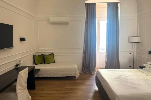 a hotel room with two beds and a window at Borgo Marsala in Trani