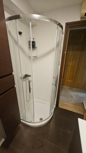 a shower with a glass door in a bathroom at Miramar Playa in La Playa de la Torre de Piles