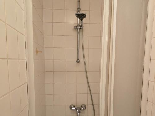 a shower with a shower head in a bathroom at B&B Mercator in Ostend