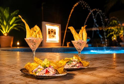 two glasses of food and chips on a table at CASTLE WHITE by MONARCA in Ríohacha
