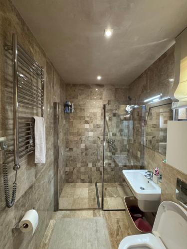 a bathroom with a shower and a sink at Azure Residence in Pržno