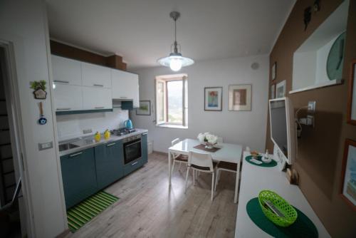 a kitchen with a table and a dining room at Casa Rosella in Sapri