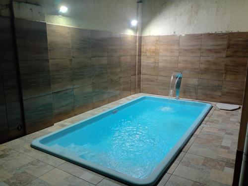 a large blue tub in a bathroom with a shower at Casa Mosqueiro in Belém