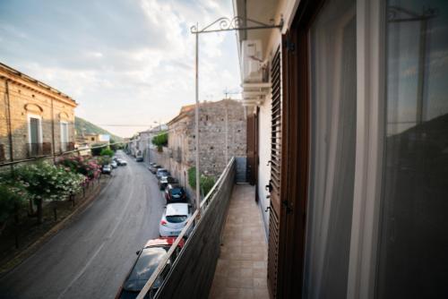 a balcony of a building with cars parked on a street at Casa Rosella in Sapri