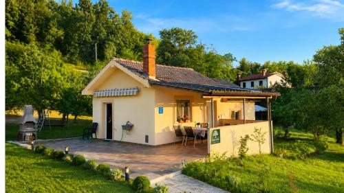 a small house with a patio in front of it at Terra Verde in Račički Brijeg