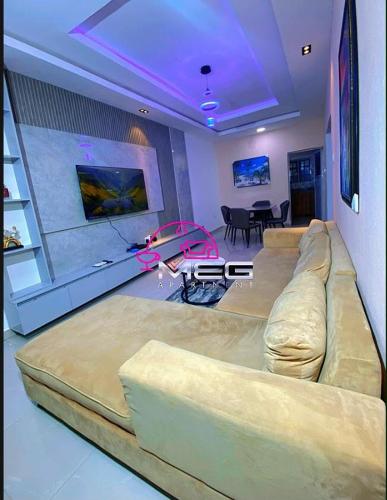 a living room with a large couch and a table at Meg Apartment in Asipa