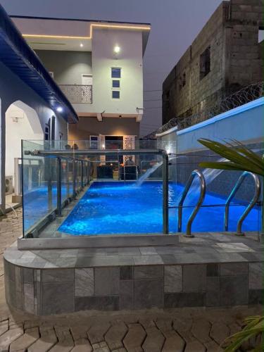 a swimming pool with blue water in a house at Meg Apartment in Asipa