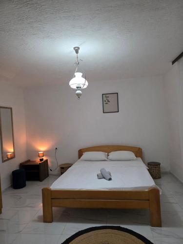 a bedroom with a bed and a light fixture at Apartments Sergej in Sutomore