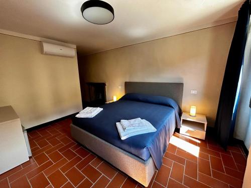 a bedroom with a bed with two towels on it at la Pace camere con bagno nel centro storico di Stia in Stia