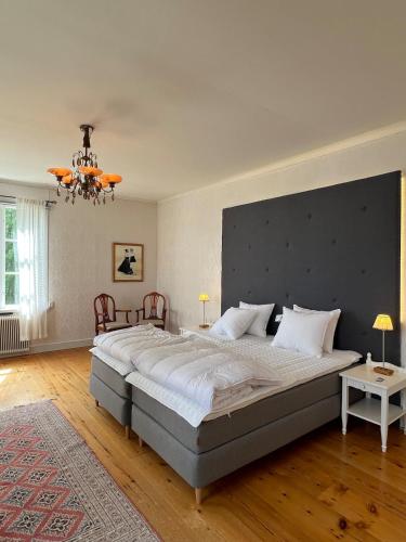 a bedroom with a large bed with a large headboard at Anders-Pers, The apartment downstairs in Järvsö