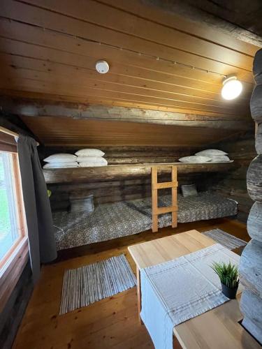 a room with pillows and a bed in a cabin at Kangasjoki Riverside Camp in Suomussalmi