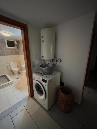 a kitchen with a water tank on top of a washing machine at Vouzianas home in Kefallonia