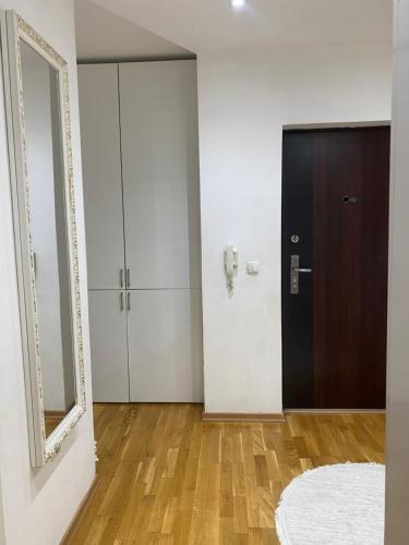 a hallway with a door and a mirror at AJ Apartments in Kosovo Polje