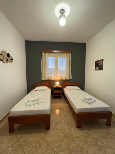 two twin beds in a room with a window at Dream Catcher3 in Agia Theodoti